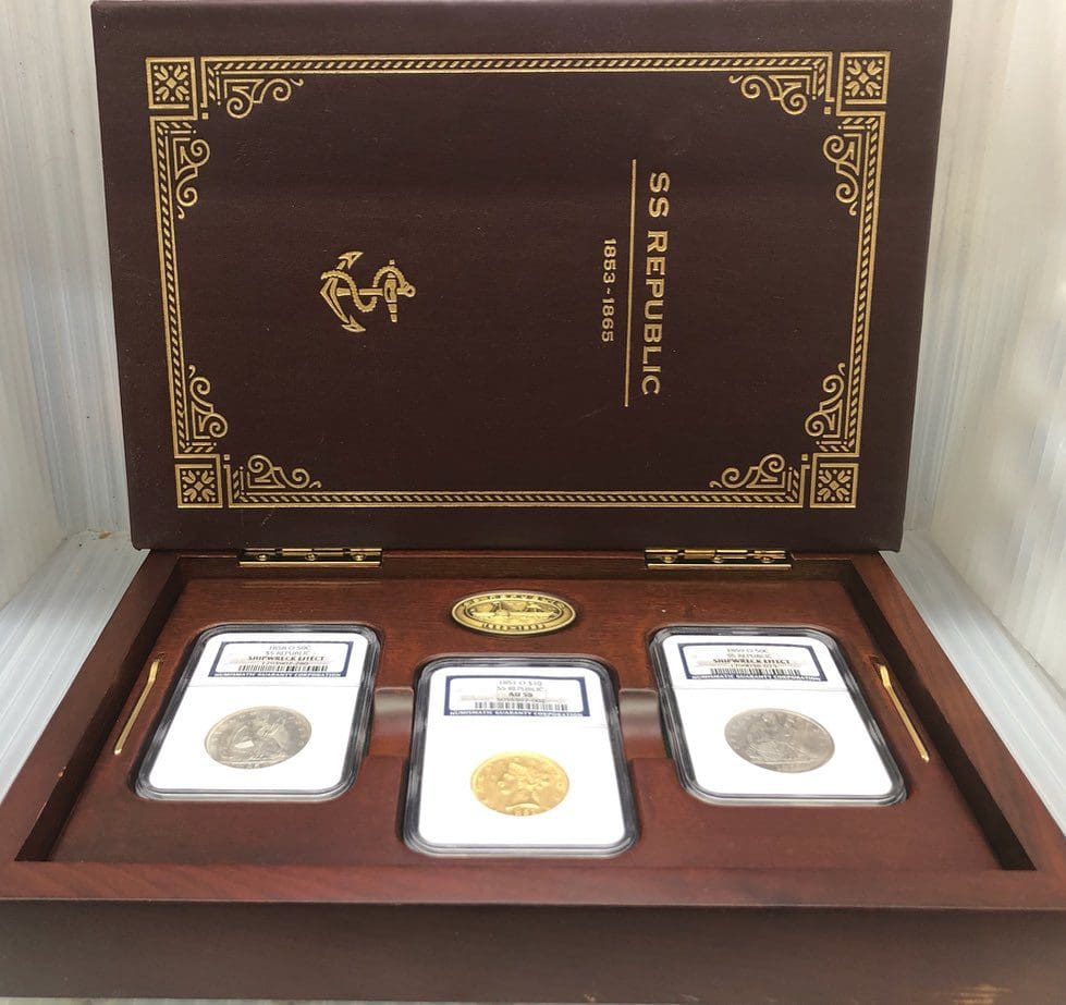 A wooden box with three different coins in it