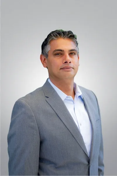 A man in a suit and tie standing up.